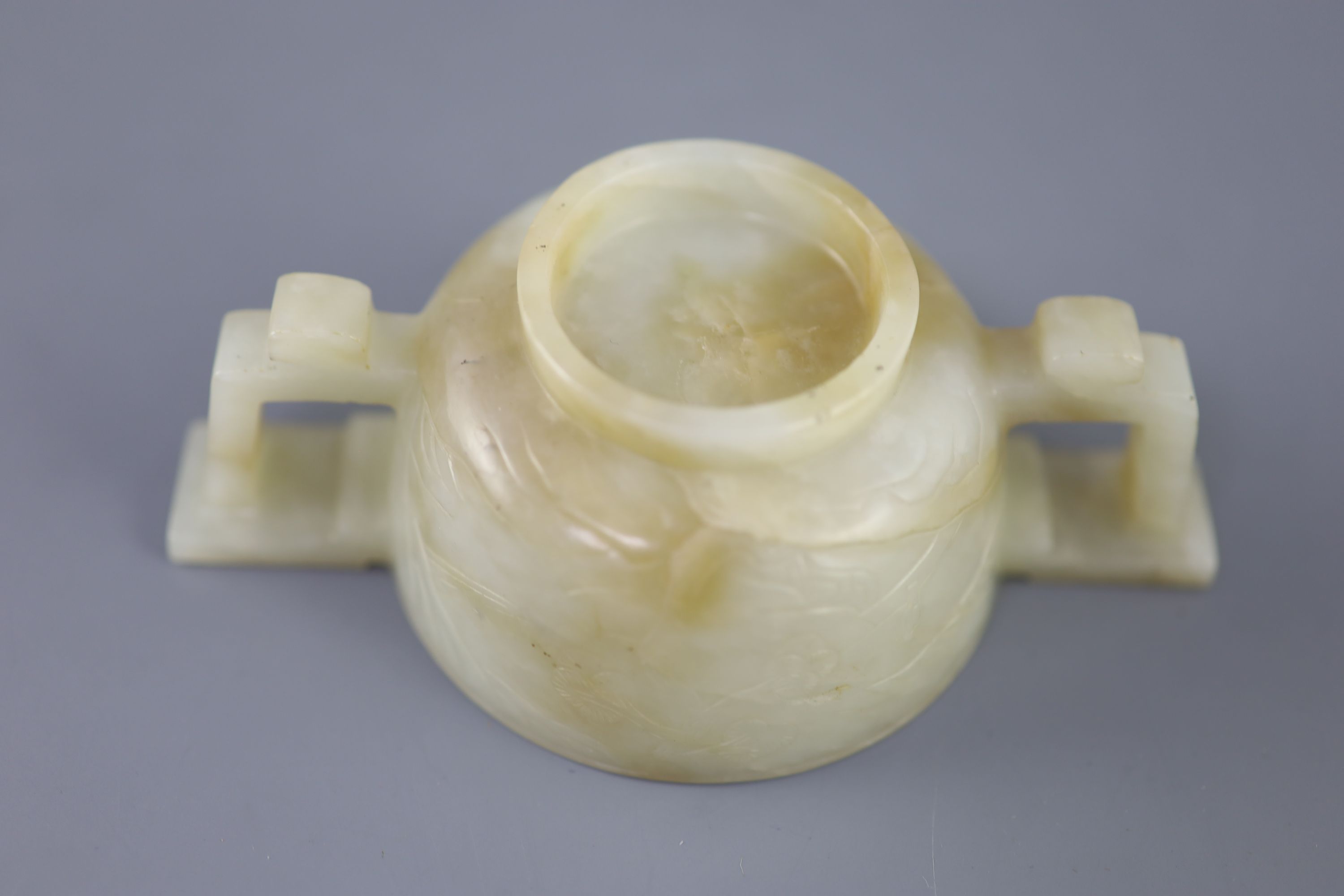 A Chinese pale celadon and russet jade cup, 17th/18th century, 12.5cm wide